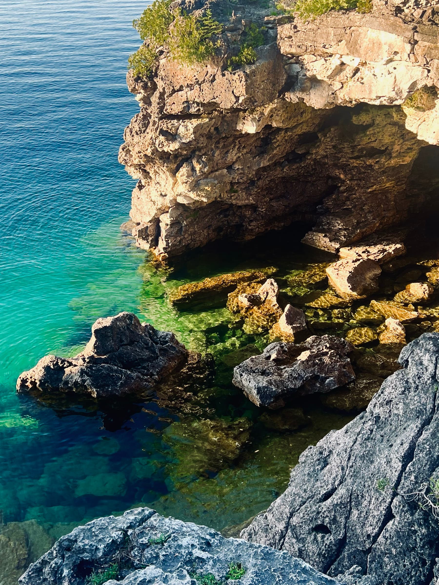 Clear turquoise water beneath limestone cliffs at the Grotto
