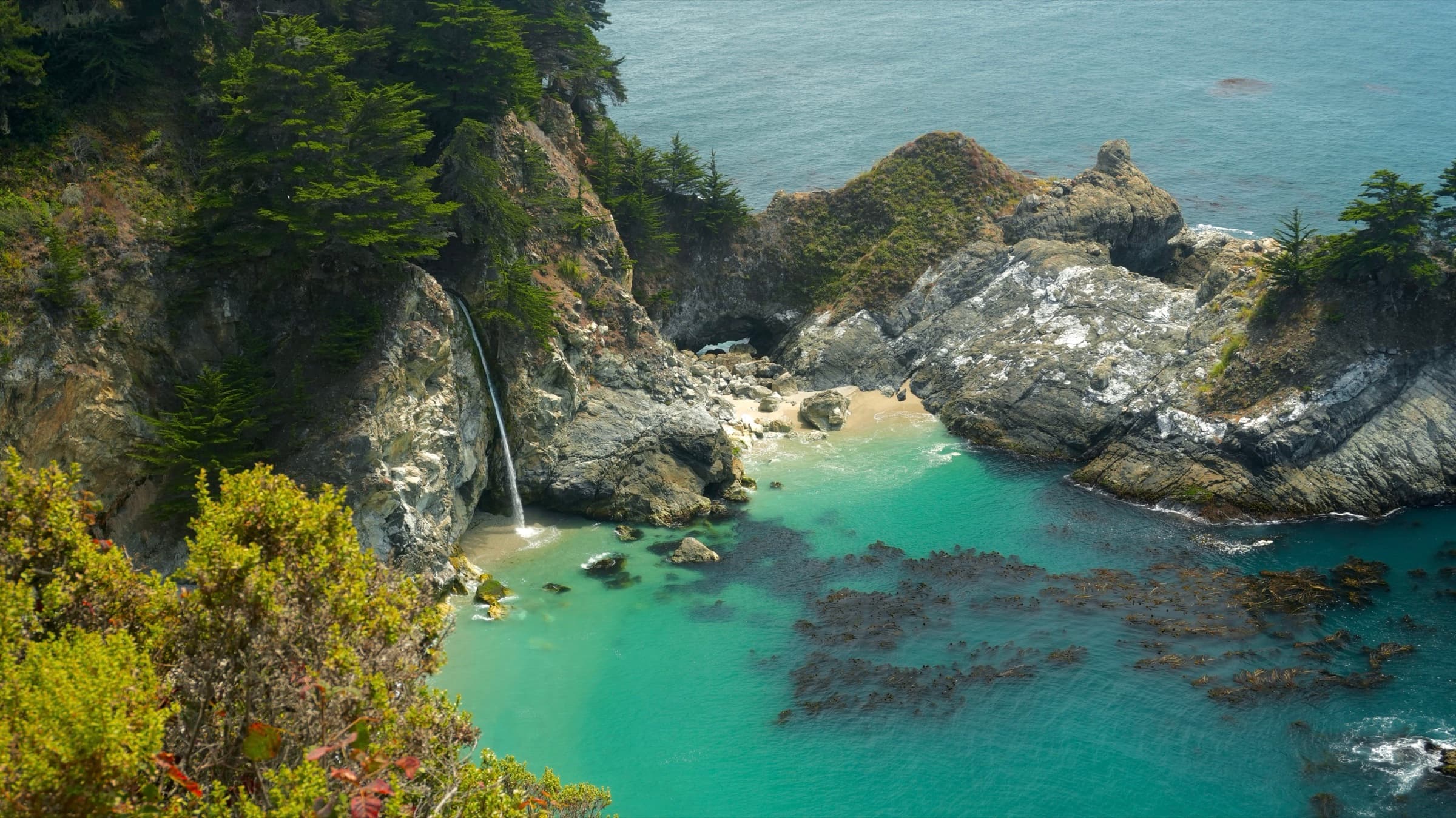 McWay Falls dropping onto the beach of a turquoise cove